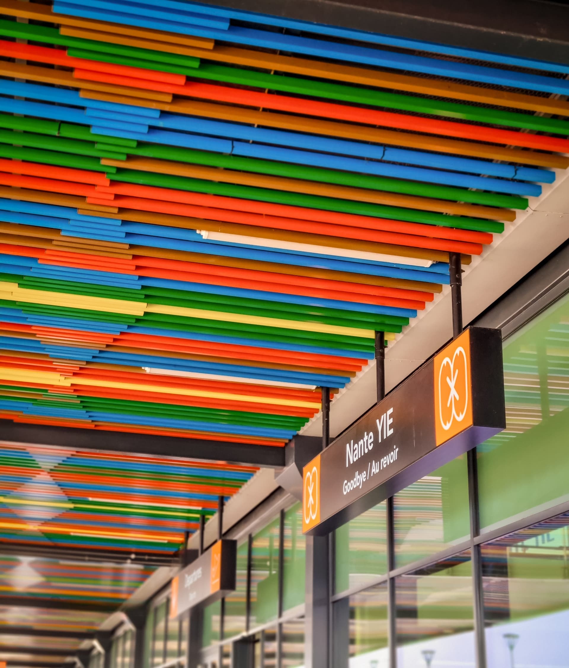 Colorful striped ceiling in an airport with a departures sign